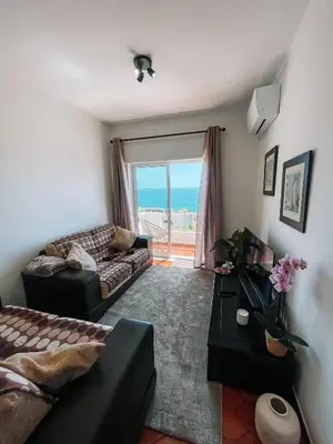 a living room with a view of the ocean at Casa Amar- Vista panorâmica in Luz