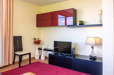 a living room with a tv and a table with a lamp at Hikers Haven in Faial