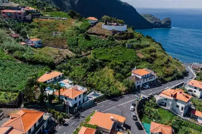 an aerial view of a town on a hill next to the ocean at Hikers Haven in Faial