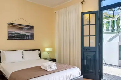 a bedroom with a bed with two towels on it at Hikers Haven in Faial
