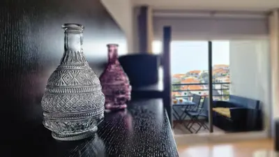 two glass bottles are sitting on a table at Azenha Apartment by LovelyStay in Caniço