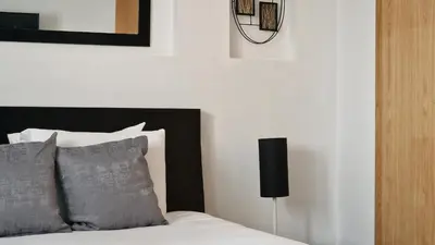 a bedroom with a bed with a black headboard at Azenha Apartment by LovelyStay in Caniço
