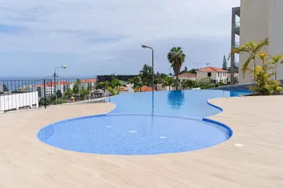 a large swimming pool on the side of a building at SeaLaVie Apartment in Funchal