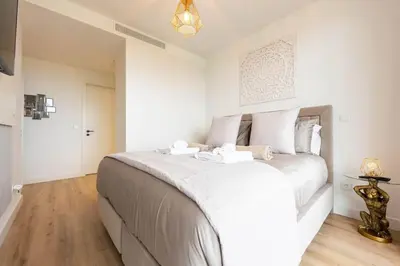 a bedroom with a large bed with white sheets at SeaLaVie Apartment in Funchal