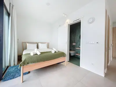 a bedroom with a bed and a bathroom at Mar Yam Garden by Atlantic Holiday in Arco de São Jorge