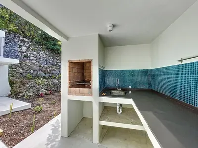 a bathroom with a sink and a stone wall at Mar Yam Garden by Atlantic Holiday in Arco de São Jorge