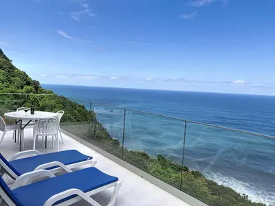 a dining table on a balcony with a view of the ocean at Mar Yam View by Atlantic Holiday in Arco de São Jorge