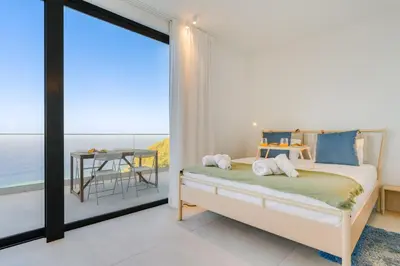 a living room with a blue couch and a table at Mar Yam View by Atlantic Holiday in Arco de São Jorge