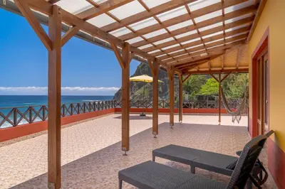 a patio with a view of the ocean at Maiata Beach House by Holiday Rental Madeira in Porto da Cruz