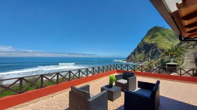 a view of the ocean from a hotel balcony at Maiata Beach House by Holiday Rental Madeira in Porto da Cruz