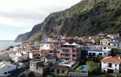 a village on the side of a mountain at Boutique Hotel Jardim Do Mar in Jardim do Mar