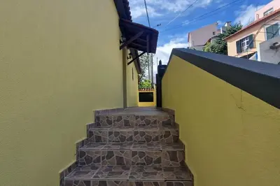 a stairway leading up to a building with a yellow door at casa sousa in Campanário
