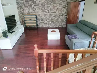 a living room with a couch and a table at casa sousa in Campanário