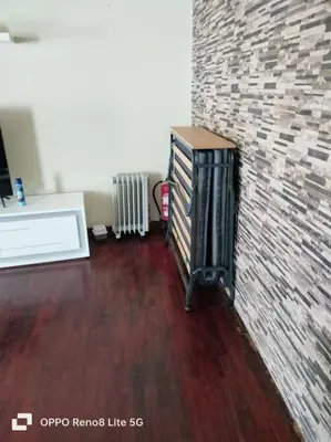 a room with a brick wall and a wooden floor at casa sousa in Campanário