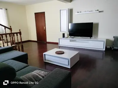 a living room with a flat screen tv and a couch at casa sousa in Campanário