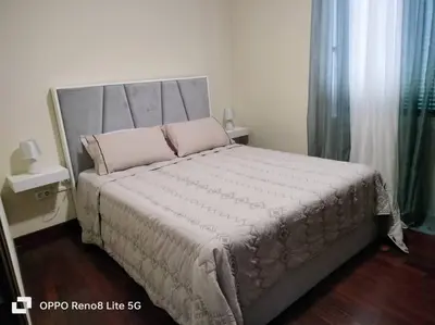 a bedroom with a large bed with pink pillows at casa sousa in Campanário
