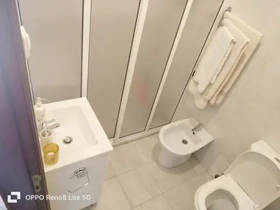 a white bathroom with a toilet and a sink at casa sousa in Campanário