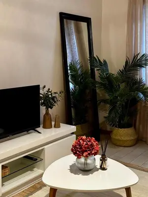 a living room with a tv and a table at Seminario Classic Apartment in Funchal