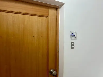 a door with a sign on it next to a room at Seminario Classic Apartment in Funchal