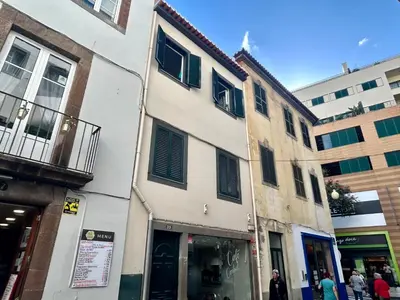a building on a street with people walking in front of it at Seminario Classic Apartment in Funchal
