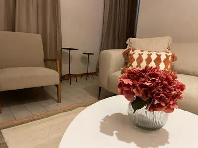 a vase with flowers on a table in a living room at Seminario Classic Apartment in Funchal