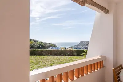 a view of the ocean from the balcony of a house at Arrifana Sunset & Surf in Aljezur