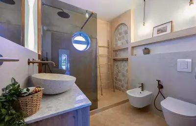 a bathroom with a large sink and a toilet at Arrifana Sunset & Surf in Aljezur