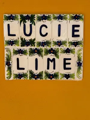 a sign with the words love love me on a wall at Lucie Lime GuestHouse in Luz