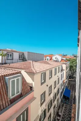 a kitchen with a stainless steel refrigerator and a washer at Old Town T1 Apartment in Funchal