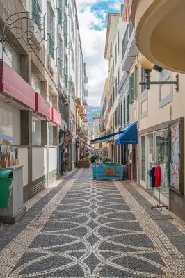 a living room with a couch and a table with chairs at Old Town T1 Apartment in Funchal