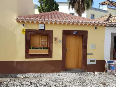 a house with a door and a window with flowers at Sao Thiago House Madeira in Funchal