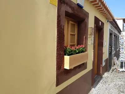 a window with a flower box on the side of a building at Sao Thiago House Madeira in Funchal