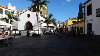 a street in a town with tables and chairs at Sao Thiago House Madeira in Funchal