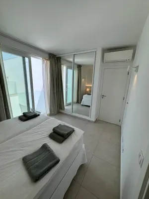 a bedroom with a bed with two towels on it at Feelgood Homestay Sagres in Sagres
