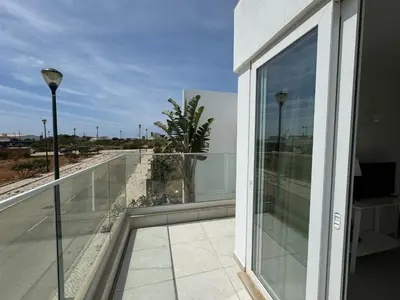a balcony with a view of the beach from a building at Feelgood Homestay Sagres in Sagres