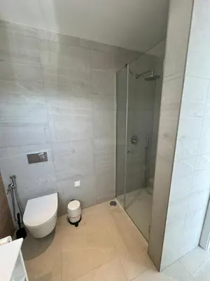 a bathroom with a toilet and a glass shower at Feelgood Homestay Sagres in Sagres