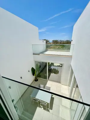 a glass floor in a house with chairs and a plant at Feelgood Homestay Sagres in Sagres