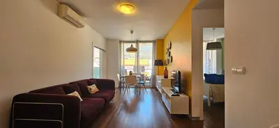 a living room with a couch and a dining room at Plaza Apartamento in Funchal