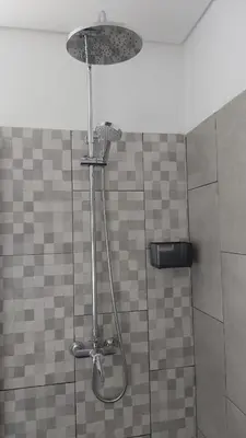 a shower with a shower head in a bathroom at Porto à Vista in Porto da Cruz