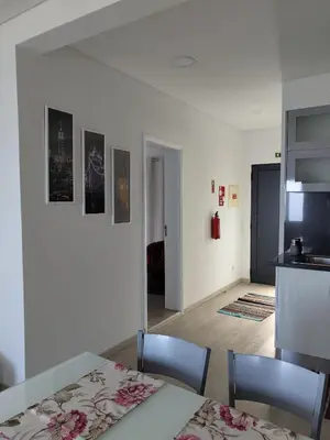 a kitchen and a dining room with a table and chairs at Porto à Vista in Porto da Cruz
