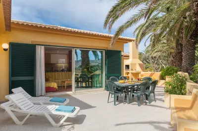 a patio with a table and chairs and a dining room at Casa do Ribeiro Salgado by An Island Apart in Porto Santo