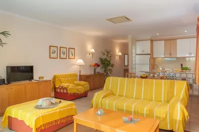 a living room with two couches and a kitchen at Casa do Ribeiro Salgado by An Island Apart in Porto Santo
