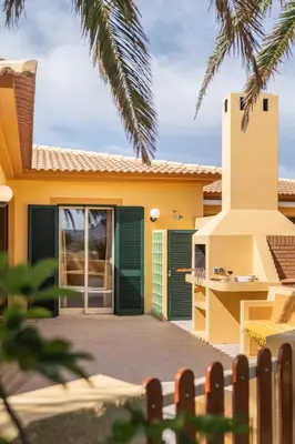a house with a green door and a fence at Casa do Ribeiro Salgado by An Island Apart in Porto Santo