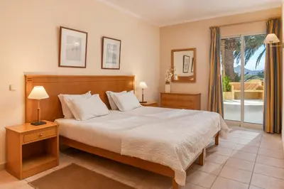 a bedroom with a large bed and a window at Casa do Ribeiro Salgado by An Island Apart in Porto Santo