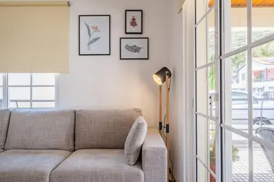 a living room with a couch and a window at Casa Flor do Campo in Calheta