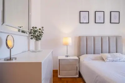 a bedroom with a bed and a table with a mirror at Casa Flor do Campo in Calheta