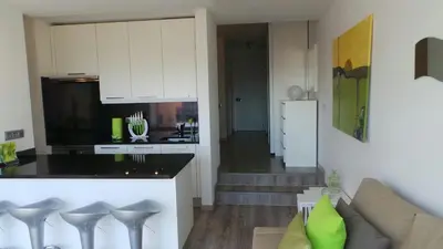 a kitchen and a living room with a couch at Ventur Balcony in Caniço