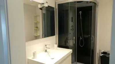a bathroom with a sink and a shower with a mirror at Ventur Balcony in Caniço