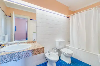 a bathroom with a toilet and a sink and a tub at O Cantinho da Mariazinha by Amazing Madeira in Funchal