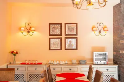 a dining room with a red table and chairs at O Cantinho da Mariazinha by Amazing Madeira in Funchal